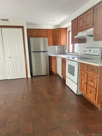 a kitchen with appliances cabinets and a sink
