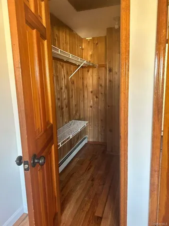 a view of a room with wooden floor and windows