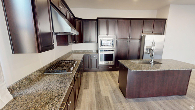 5502 North Valley View Road Lehi, UT 84048 - Photo 7 of 33 Kitchen featuring dark wood cabinetry, granite countertops, stainless steel appliances, and wood-finish flooring