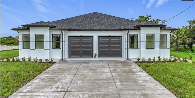a front view of a house with a yard