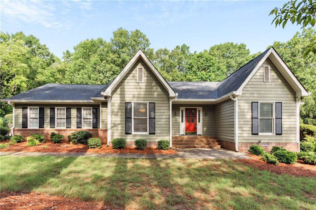 a view of a house with a yard patio and a garden