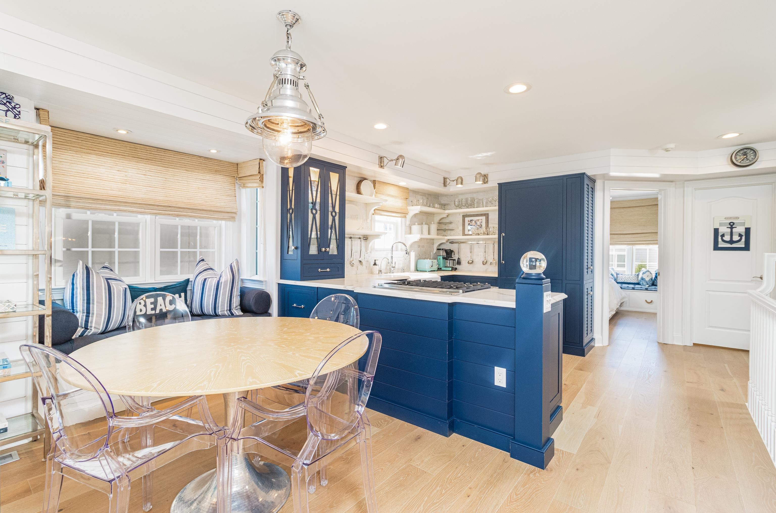 328 83rd Street Stone Harbor, NJ 08247 - Photo 12 of 34 a dining room with a kitchen island a chandelier and a wooden floors