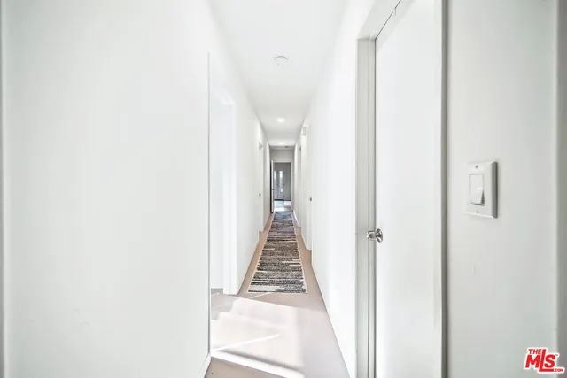 a view of a hallway with a white door