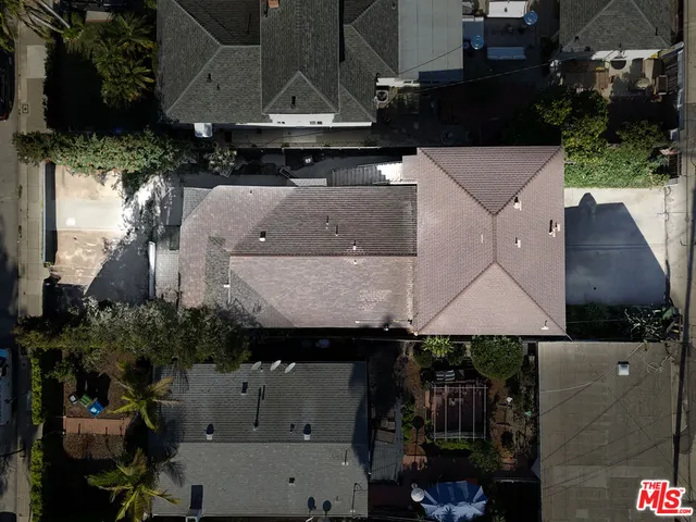 an aerial view of a house with table and chairs