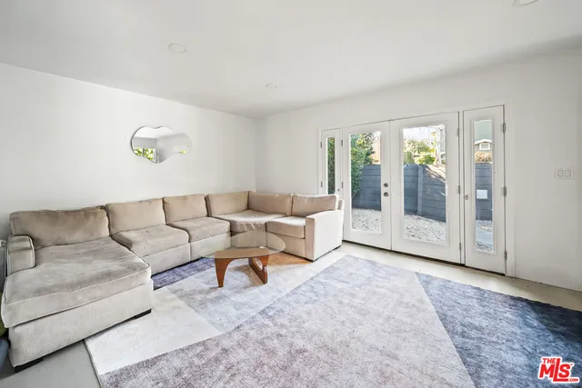 a living room with furniture and large window