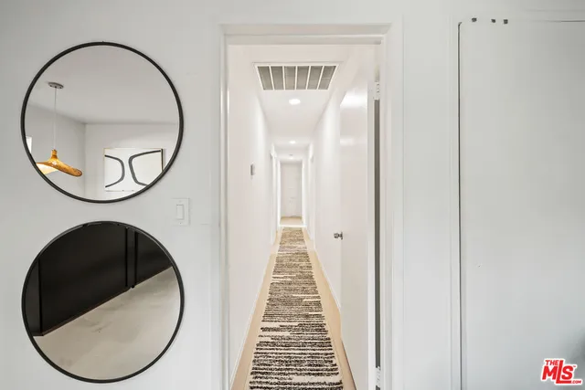 a view of a hallway with washer and dryer