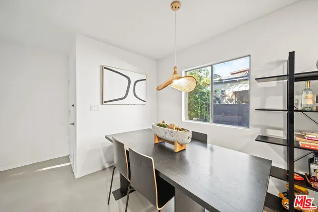 a view of a workspace with furniture and window