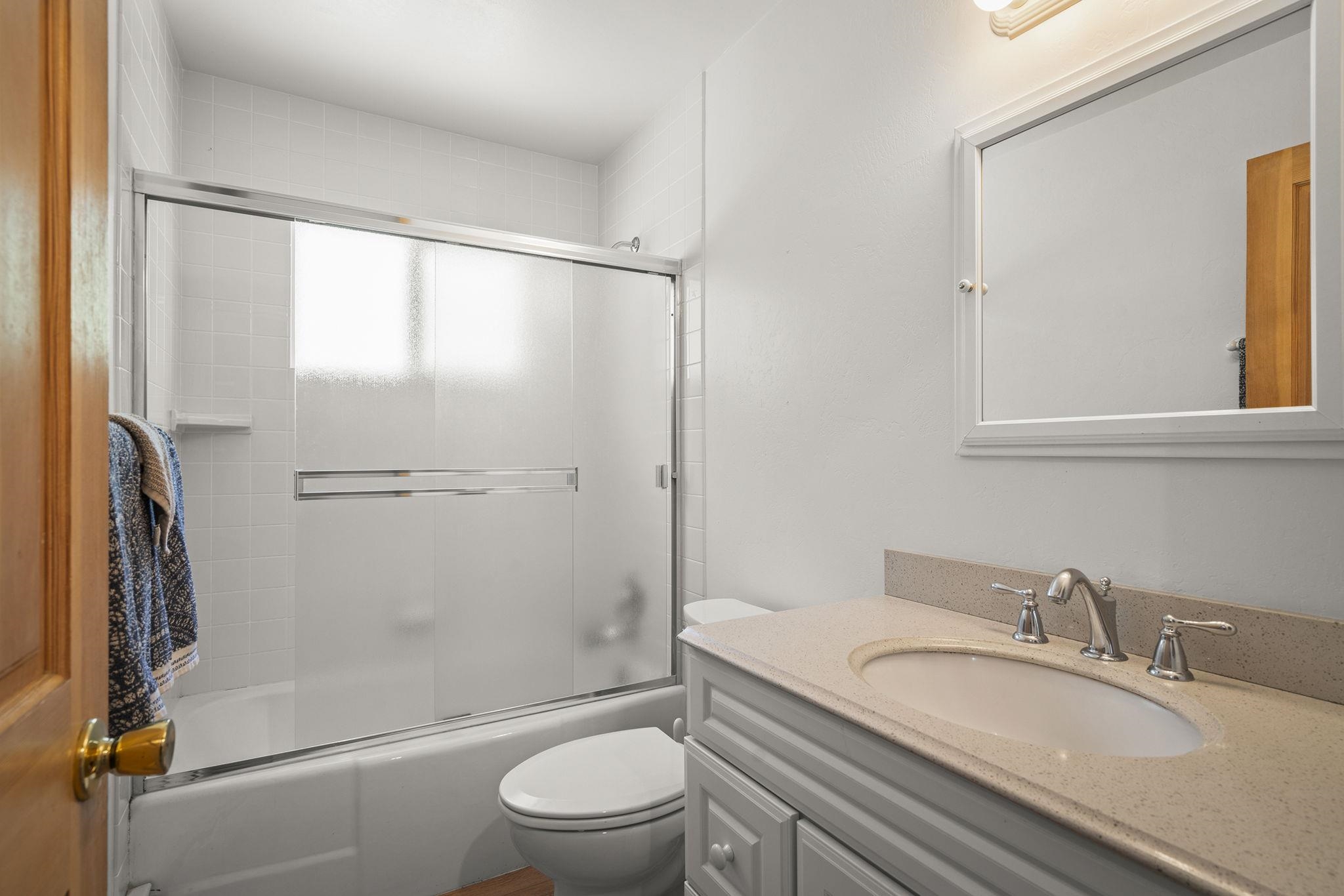 20 Observation Drive Tahoe City, CA 96145 - Photo 14 of 28 a bathroom with a granite countertop sink toilet and shower