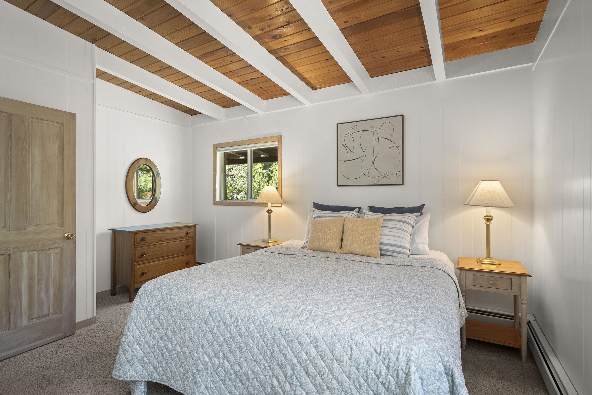 20 Observation Drive Tahoe City, CA 96145 - Photo 15 of 28 a bedroom with a bed and a lamp on dresser with a window