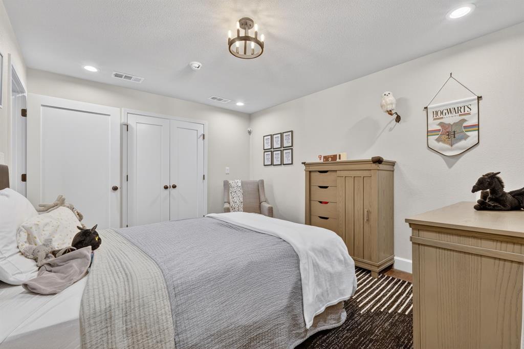608 South Dooley Street Grapevine, TX 76051 - Photo 22 of 38 a spacious bedroom with a bed and a dresser