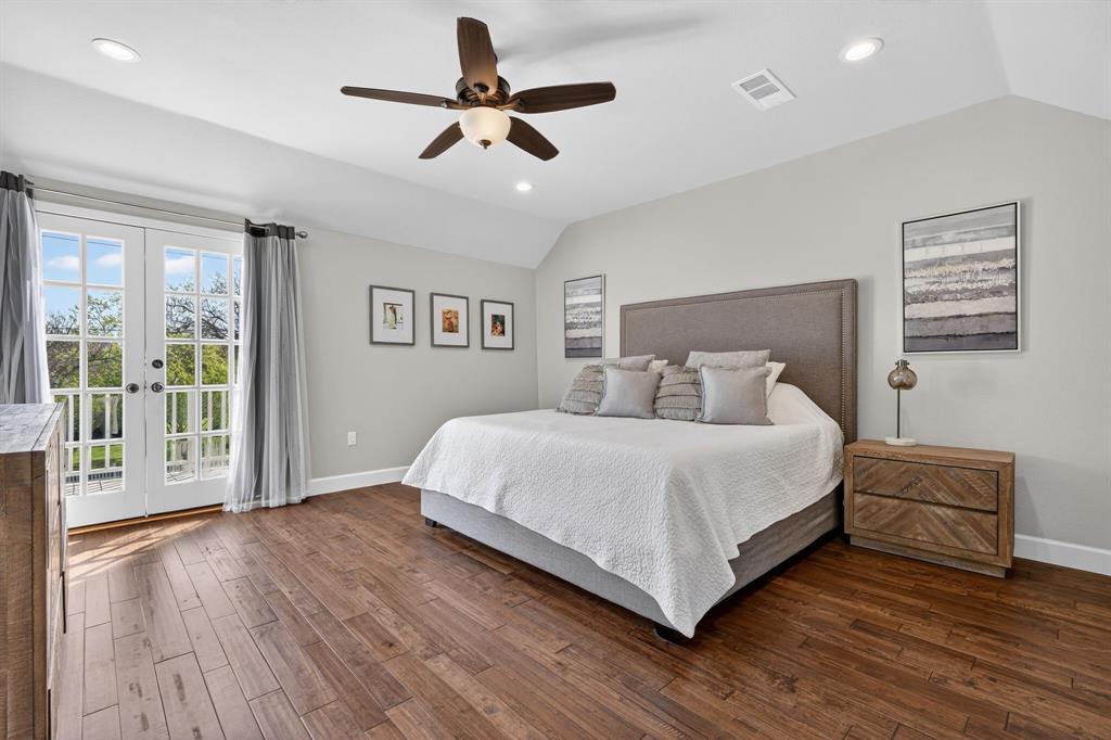608 South Dooley Street Grapevine, TX 76051 - Photo 25 of 38 a bedroom with a large bed chandelier and a window