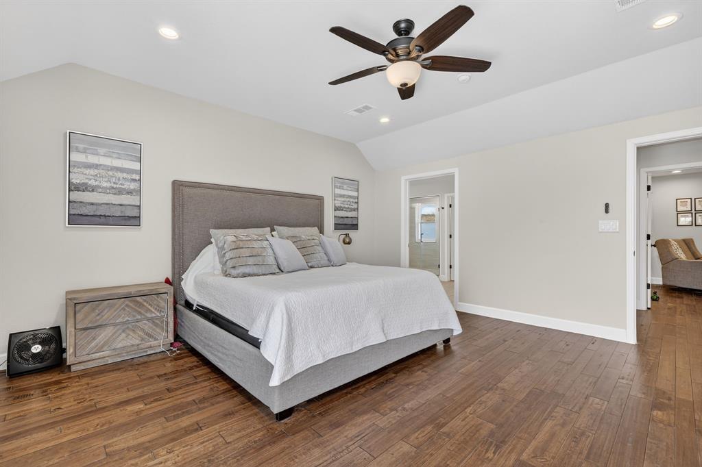 608 South Dooley Street Grapevine, TX 76051 - Photo 26 of 38 a bedroom with a large bed and a ceiling fan