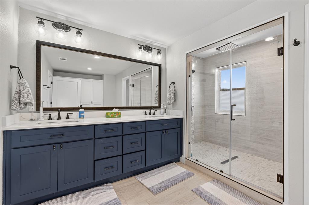 608 South Dooley Street Grapevine, TX 76051 - Photo 30 of 38 a bathroom with a shower sink and mirror