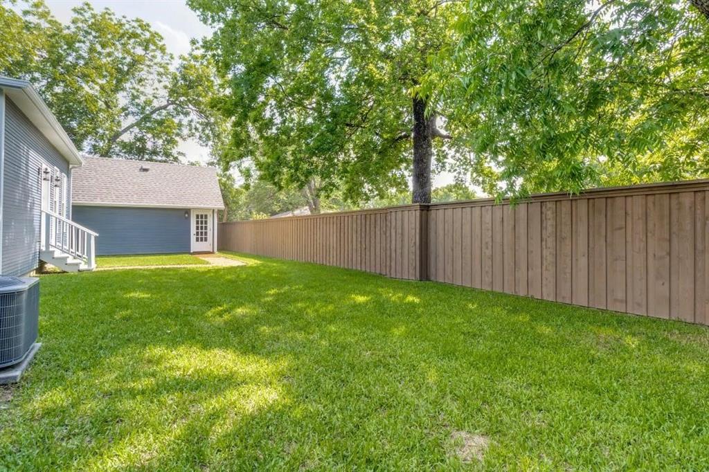 608 South Dooley Street Grapevine, TX 76051 - Photo 36 of 38 a view of a yard with a house and a large tree
