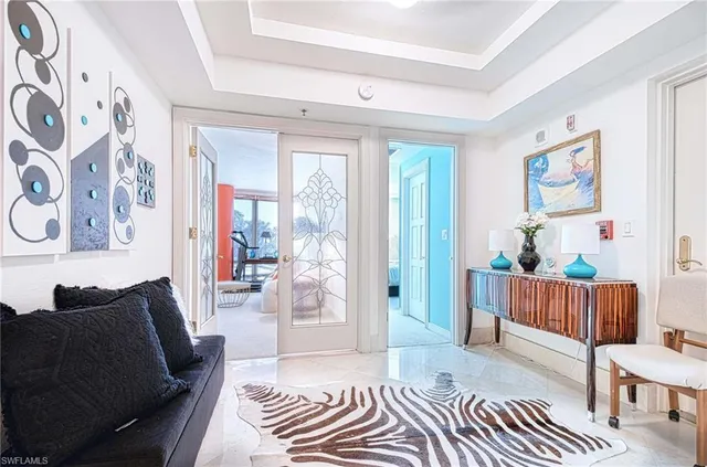 a living room with furniture and a baby crib