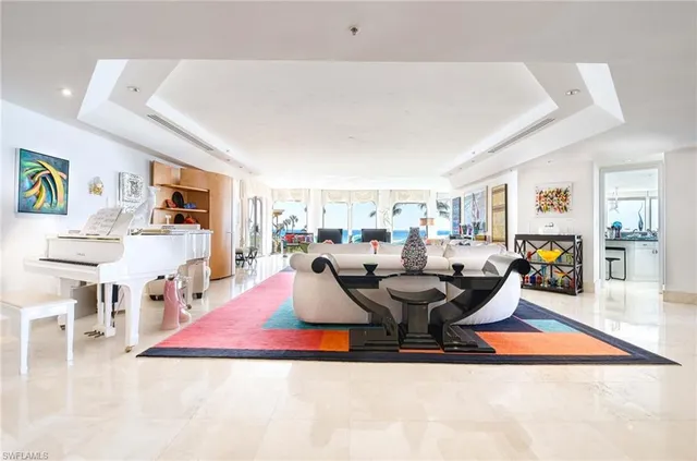 a living room with furniture pool table and view of living room
