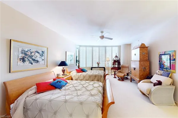 a bed room with bed and a large window