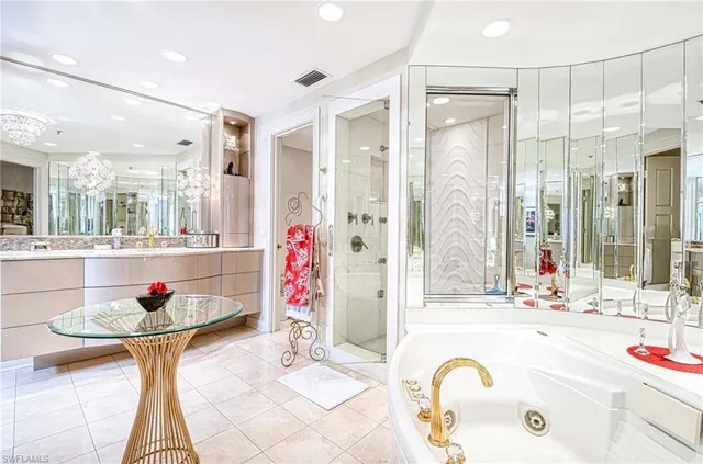 a bathroom with a granite countertop sink a mirror and shower