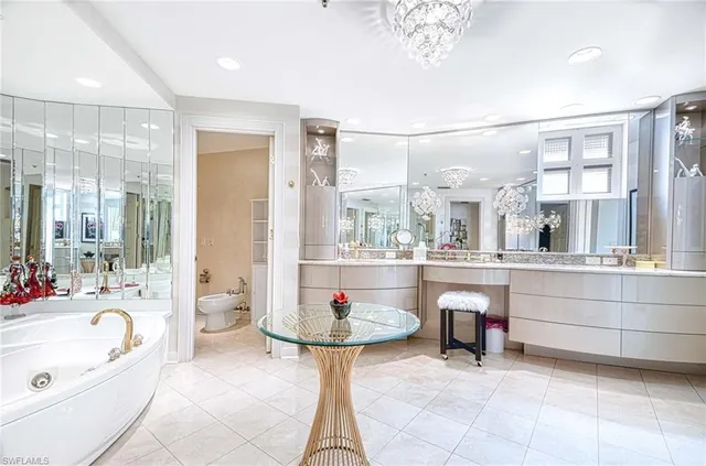 a bathroom with a tub sink and mirror