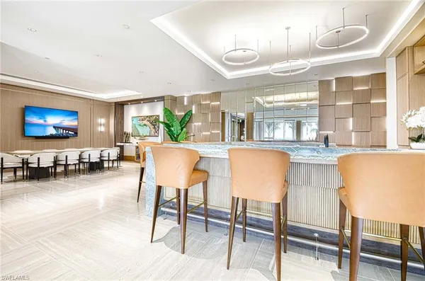 a living room with furniture a chandelier and a large window
