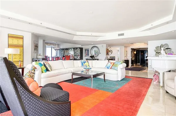 a living room with furniture fireplace and a window