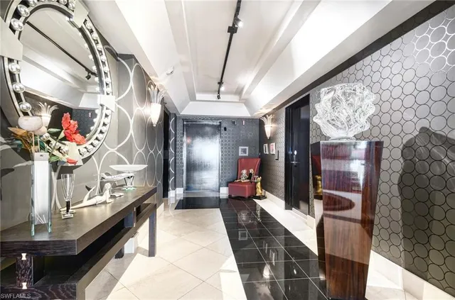 a lobby with furniture and a potted plant