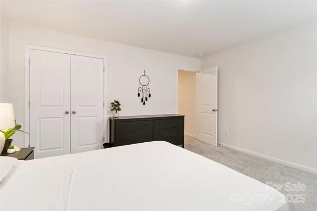 a bedroom with a bed and cabinets