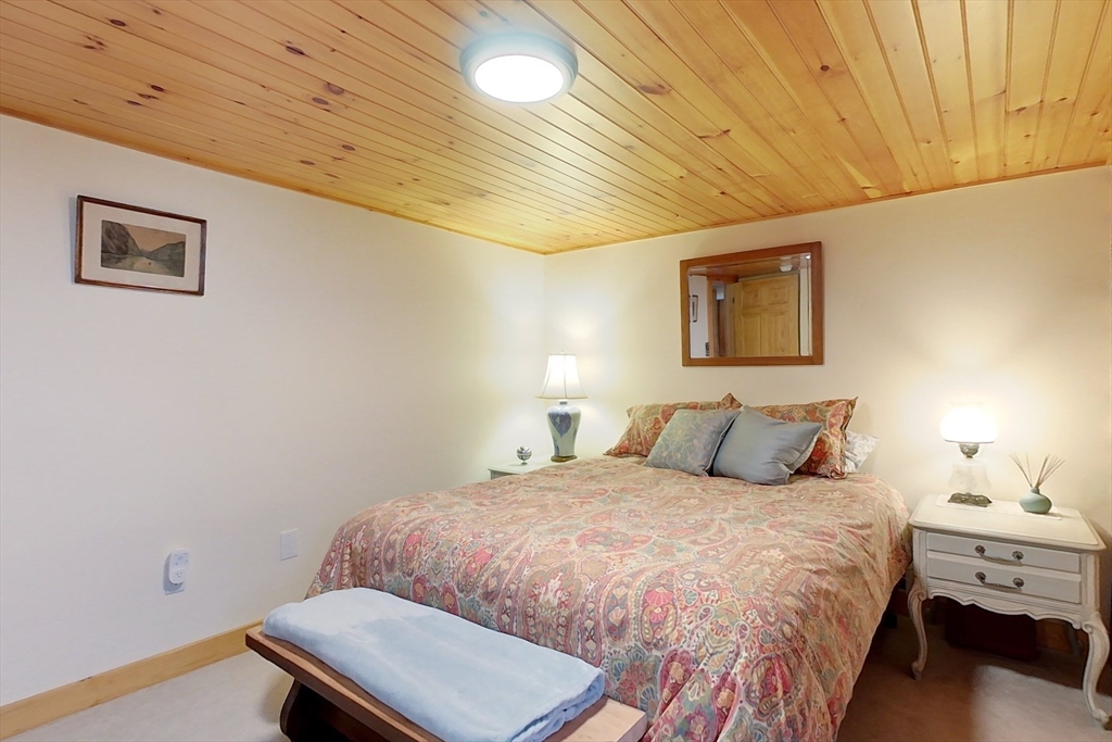 249 Pillsbury Road Ashby, MA 01431 - Photo 19 of 39 a bedroom with a bed and a lamp