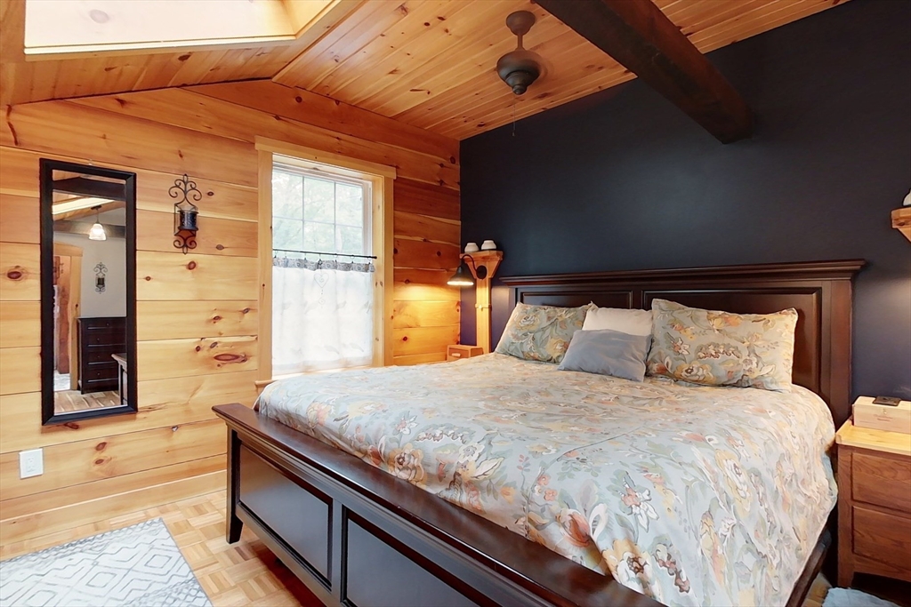 249 Pillsbury Road Ashby, MA 01431 - Photo 21 of 39 a bedroom with a bed and wooden floor