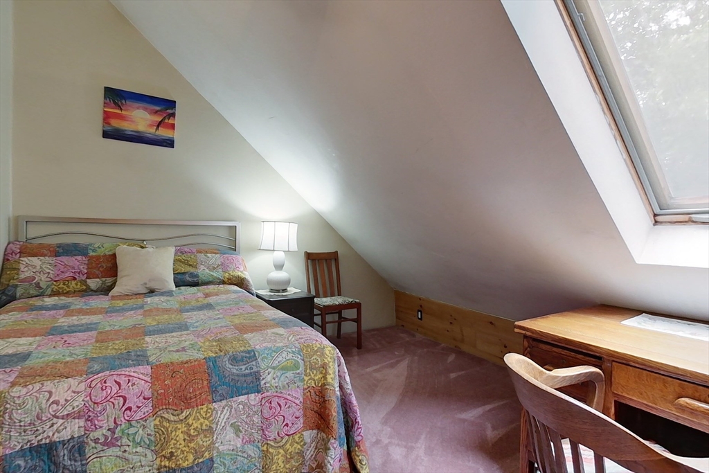 249 Pillsbury Road Ashby, MA 01431 - Photo 25 of 39 a bedroom with a bed and a lamp with the bookshelf