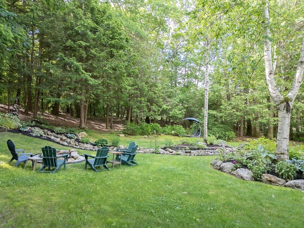 249 Pillsbury Road Ashby, MA 01431 - Photo 31 of 39 a view of backyard with table and chairs and wooden fence