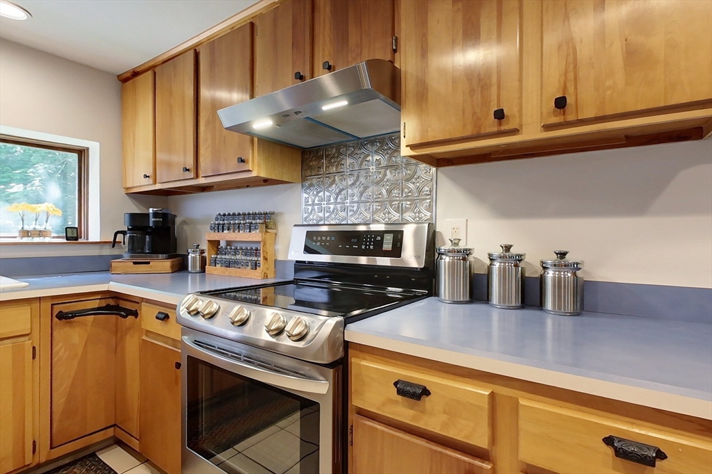 249 Pillsbury Road Ashby, MA 01431 - Photo 4 of 39 a kitchen with stainless steel appliances granite countertop a sink a stove and a microwave