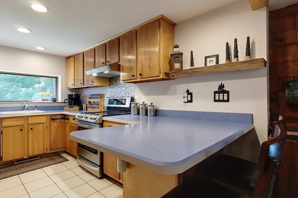 249 Pillsbury Road Ashby, MA 01431 - Photo 6 of 39 a kitchen with stainless steel appliances a sink a stove top oven a counter space and cabinets