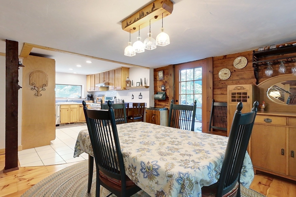 249 Pillsbury Road Ashby, MA 01431 - Photo 7 of 39 a view of a dining room with furniture and a chandelier
