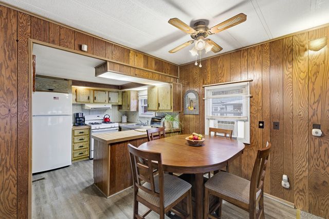 a kitchen that has a table and chairs in it