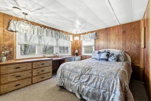 a spacious bedroom with a bed and a window