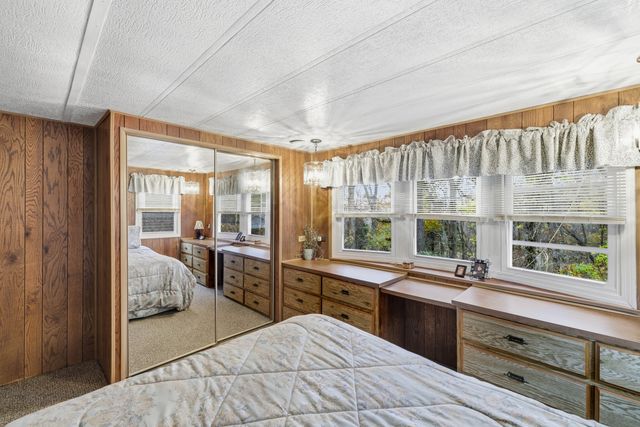 a large kitchen with kitchen island granite countertop a large window and a sink