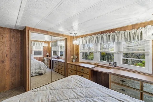 a large kitchen with kitchen island granite countertop a large window and a sink