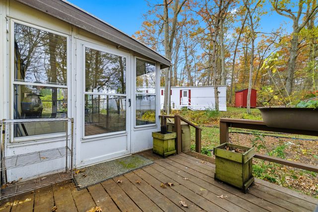 a view of a chairs and table on the wooden deck