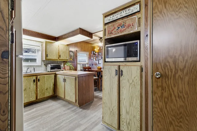 a kitchen with a refrigerator and a stove