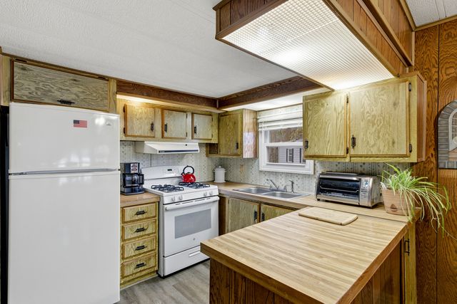 a kitchen with a refrigerator a stove a sink and a refrigerator