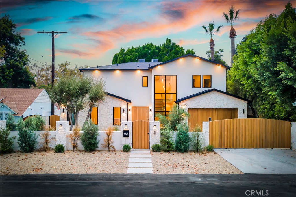 5149 Beeman Avenue Valley Village, CA 91607 - Photo 1 of 21 a front view of a house with a yard and garage