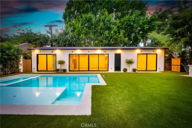 a view of swimming pool with a patio and a yard
