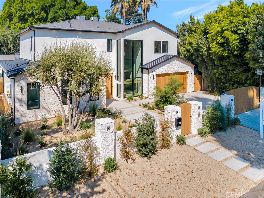 5149 Beeman Avenue Valley Village, CA 91607 - Photo 3 of 21 a front view of a house with a yard