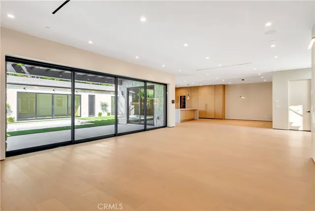 a large kitchen with stainless steel appliances a large counter top a stove and a refrigerator