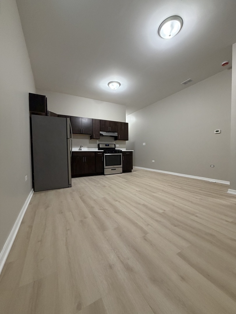 22 North Pulaski Road, Unit 1R Chicago, IL 60624 - Photo 9 of 22 a large white room with kitchen island