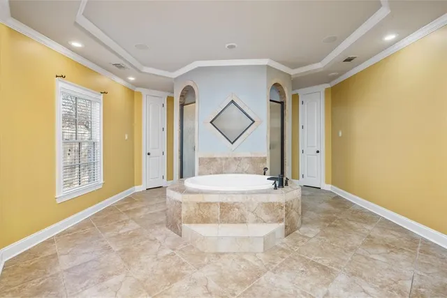 a view of an empty room with a fireplace and a window