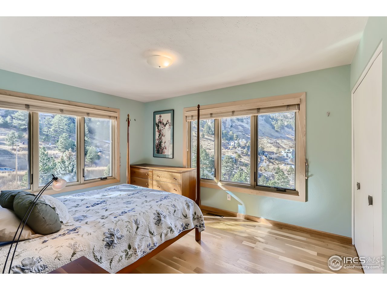 389 South Cedar Brook Road Boulder, CO 80304 - Photo 12 of 30 a bedroom with a large bed and a large window
