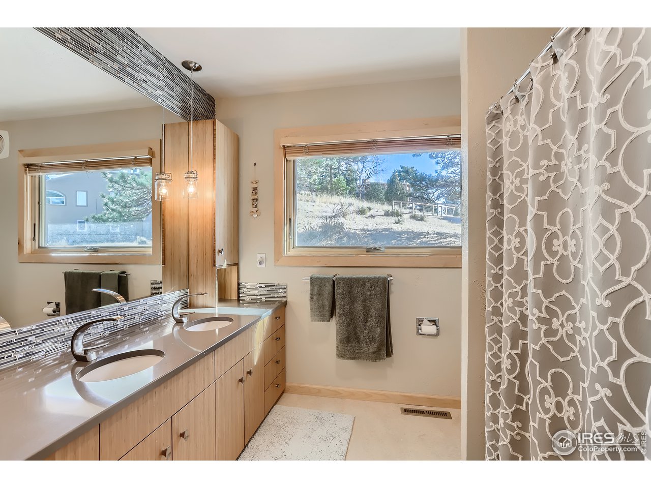 389 South Cedar Brook Road Boulder, CO 80304 - Photo 15 of 30 a bathroom with a granite countertop sink a mirror a window and a shower
