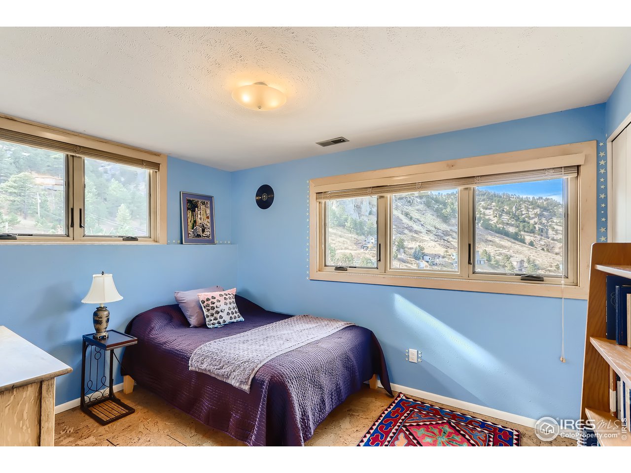 389 South Cedar Brook Road Boulder, CO 80304 - Photo 16 of 30 a bedroom with a bed and a large window